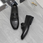 Leather loafer set in black with metal strap buckle and low block sole
