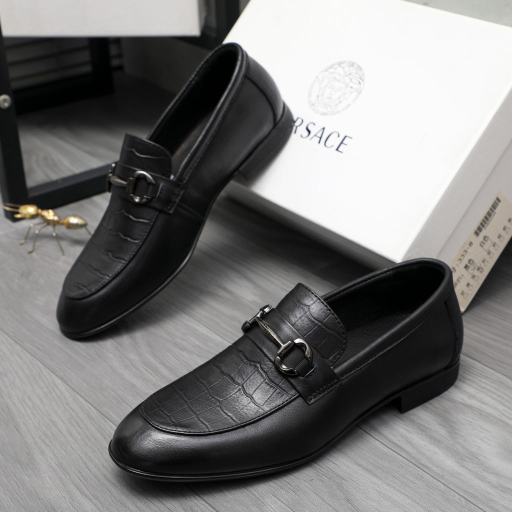 Black leather loafer with strap buckle detail and rounded moc toe