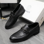 Black leather loafer with strap buckle detail and rounded moc toe