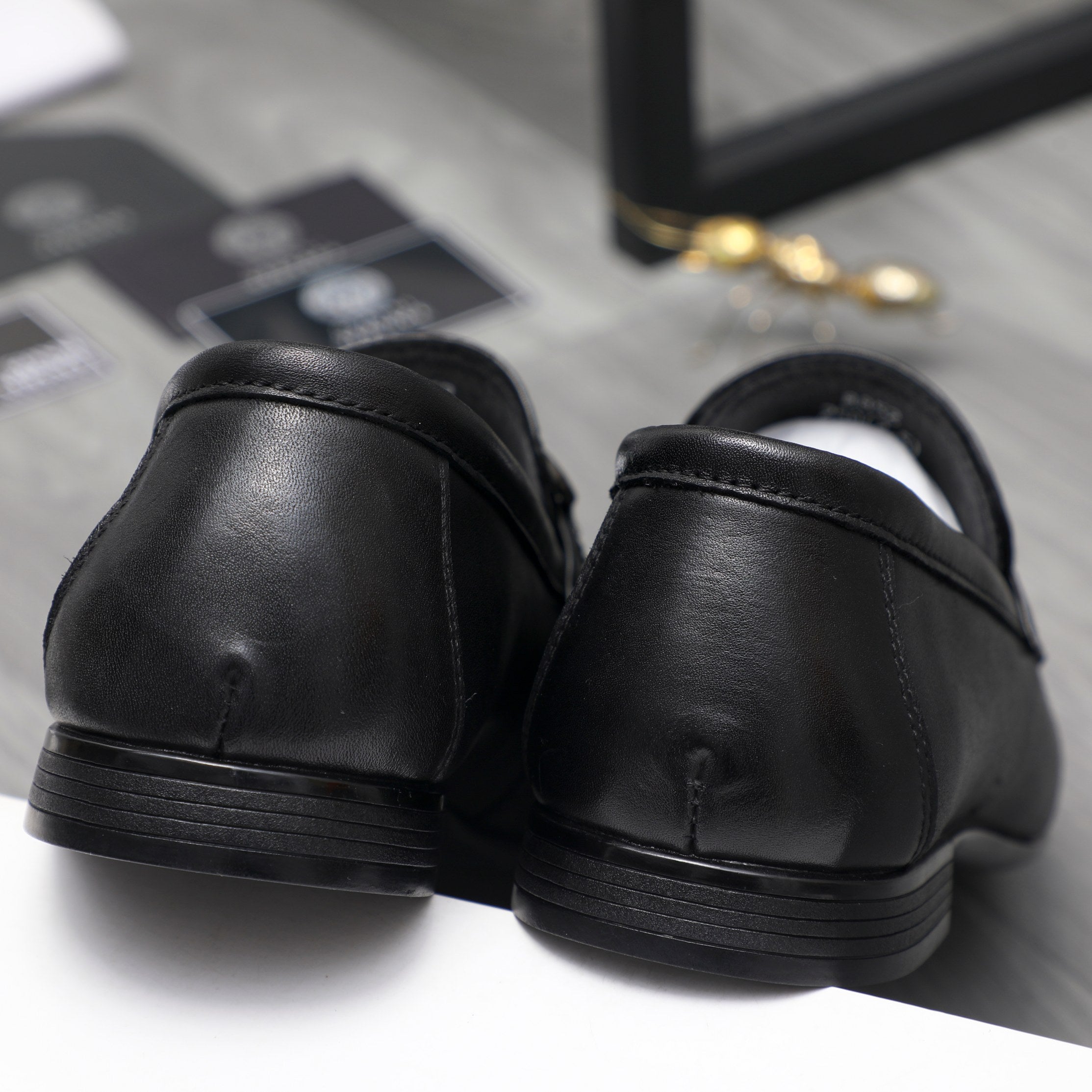 Leather loafer heel view in black with smooth back and ridged sole