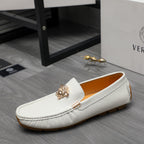 White leather loafer with gold emblem and metal bar, low-profile sole