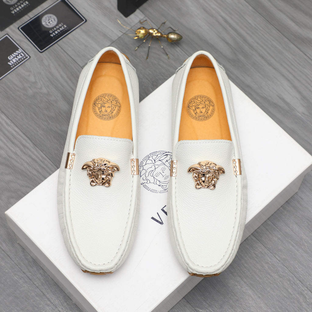 White leather slip-on loafers with gold emblem, front view
