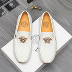 White leather slip-on loafers with gold emblem, front view