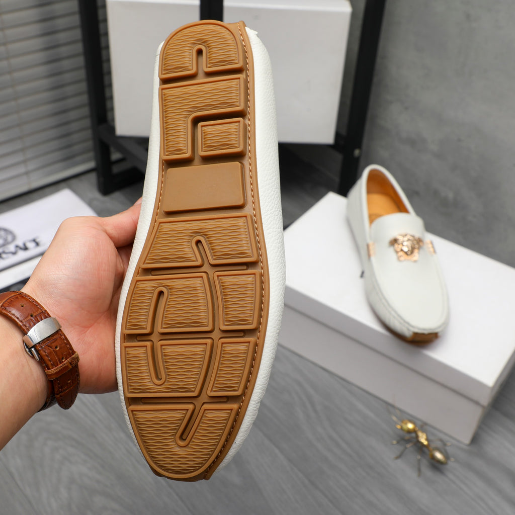 Loafer sole view: white upper with brown rubber tread and embossed pattern