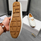Loafer sole view: white upper with brown rubber tread and embossed pattern