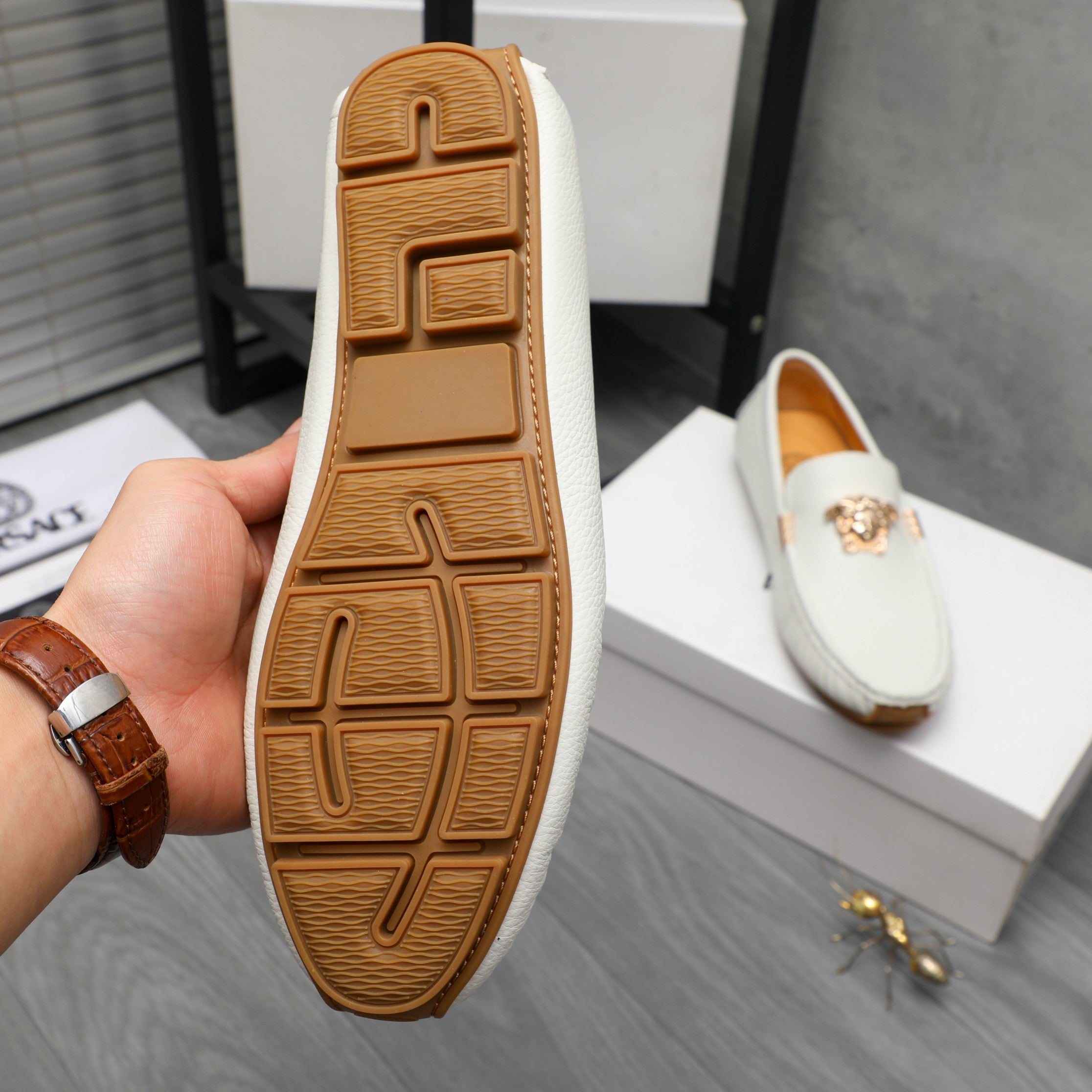 Loafer sole view: white upper with brown rubber tread and embossed pattern