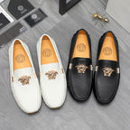 Leather loafers with gold emblem hardware, white and black, slip-on style