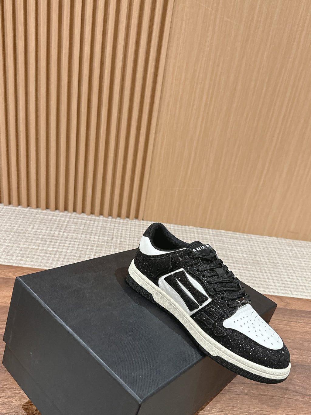 Amiri low-top sneakers on black box, black glitter, white side panel, lace-up