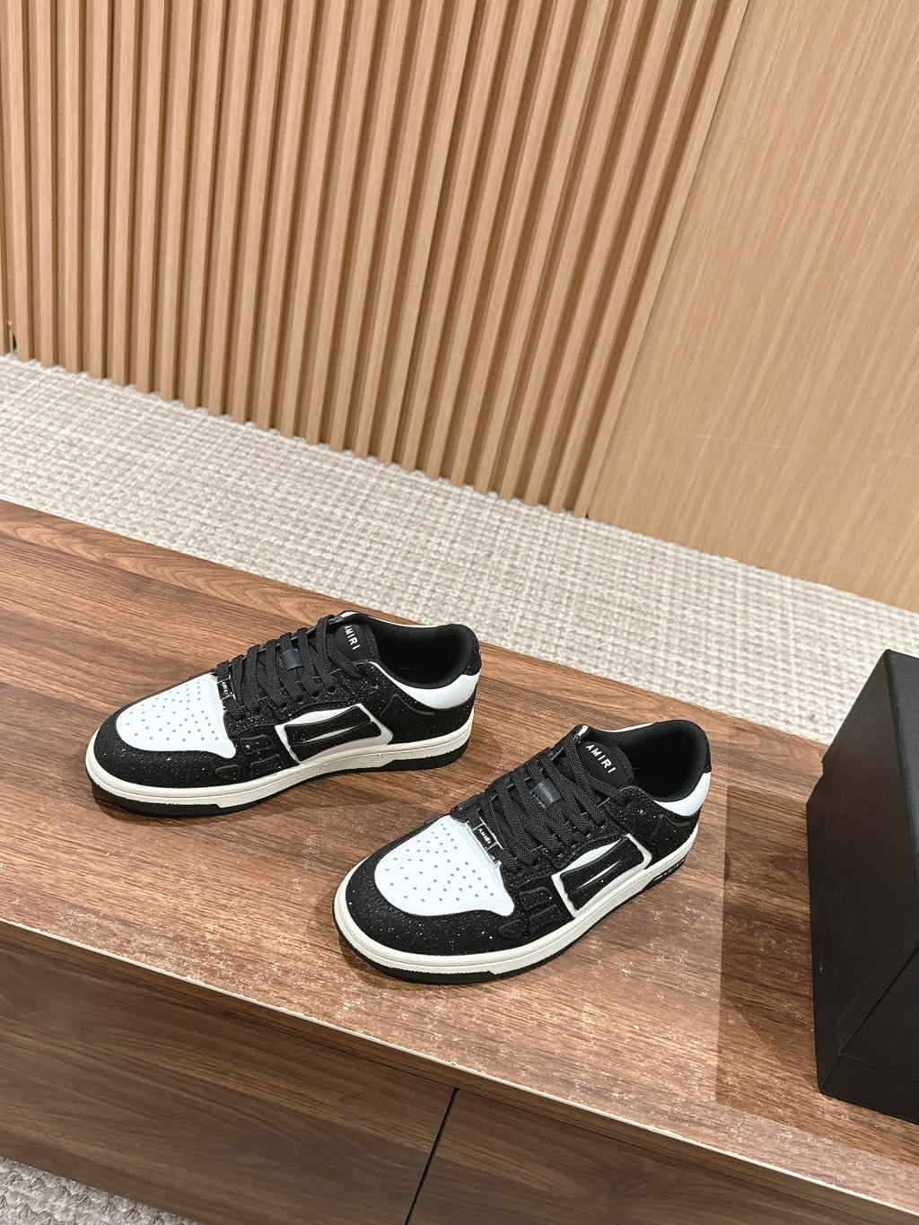 Amiri low-top sneakers pair, black glitter with white toe and side panels, black laces