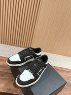 Amiri low-top sneakers pair, black glitter with white toe and side panels, lace-up