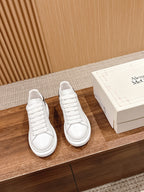 White Alexander McQueen leather sneakers, lace-up style with smooth toe caps