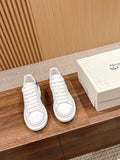 Pair of white low-top lace-up sneakers with black heel accents