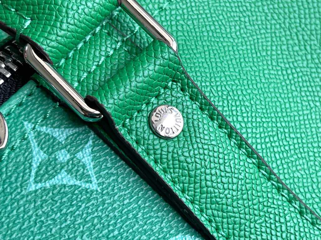 Louis Vuitton men’s green duffel bag close-up of textured leather and round logo button