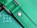 Louis Vuitton men’s green duffel bag close-up of textured leather and round logo button