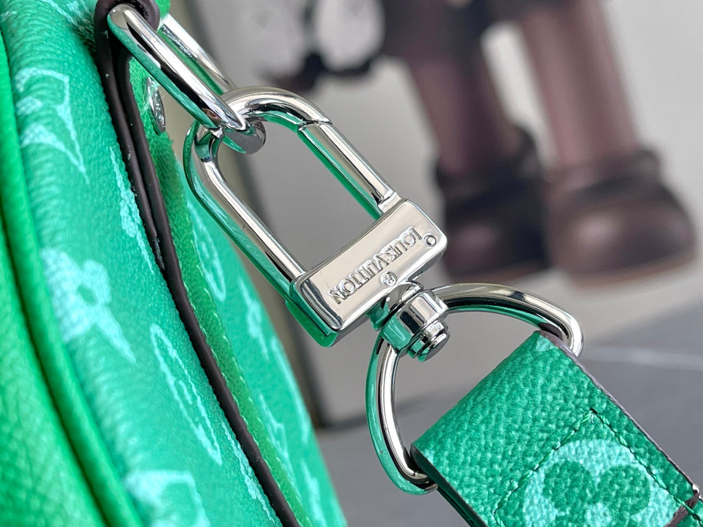 Louis Vuitton handbag key ring and metal clasp with green strap and monogram canvas.