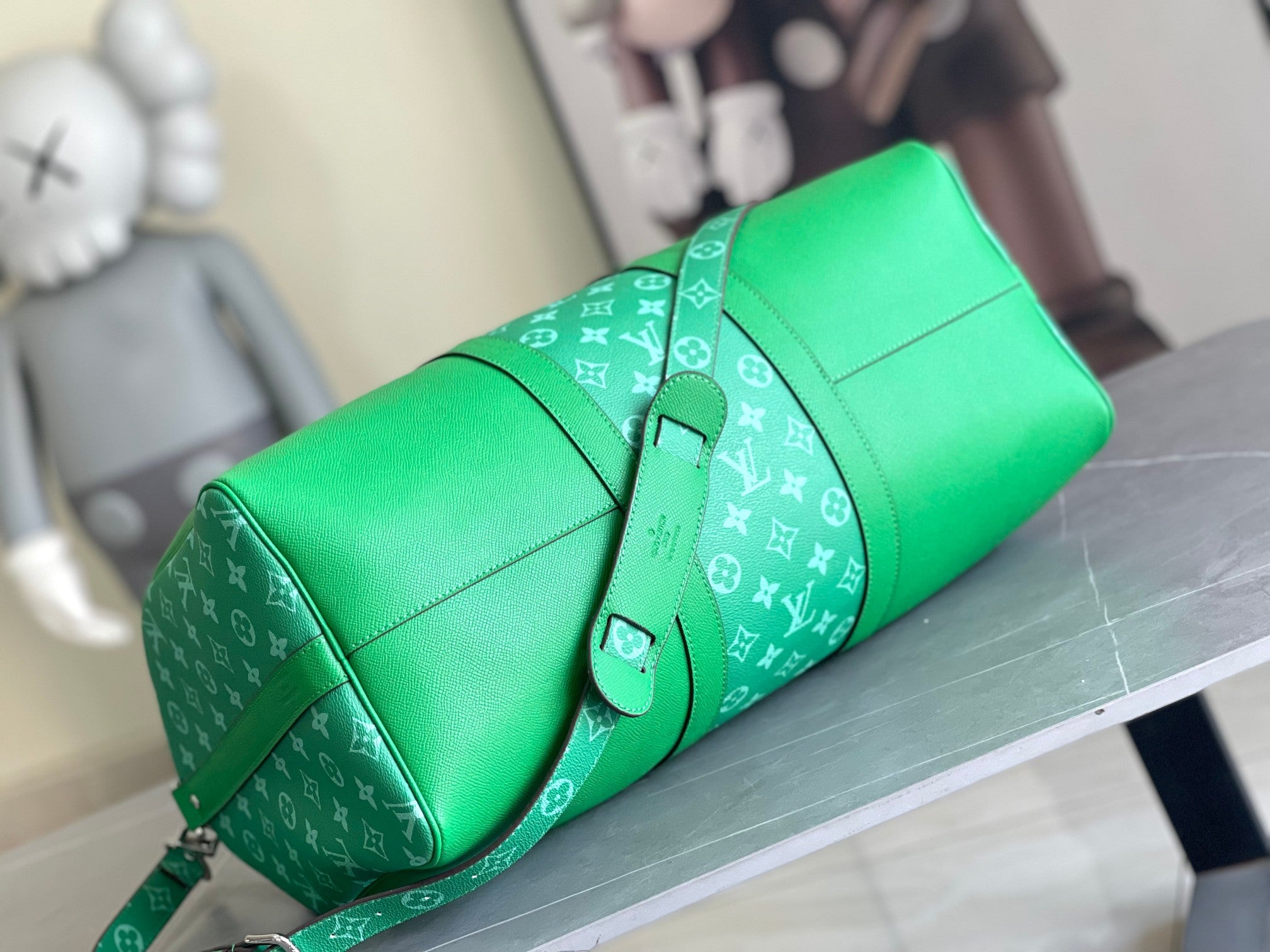 Green Louis Vuitton monogram handbag with short handles and adjustable strap.