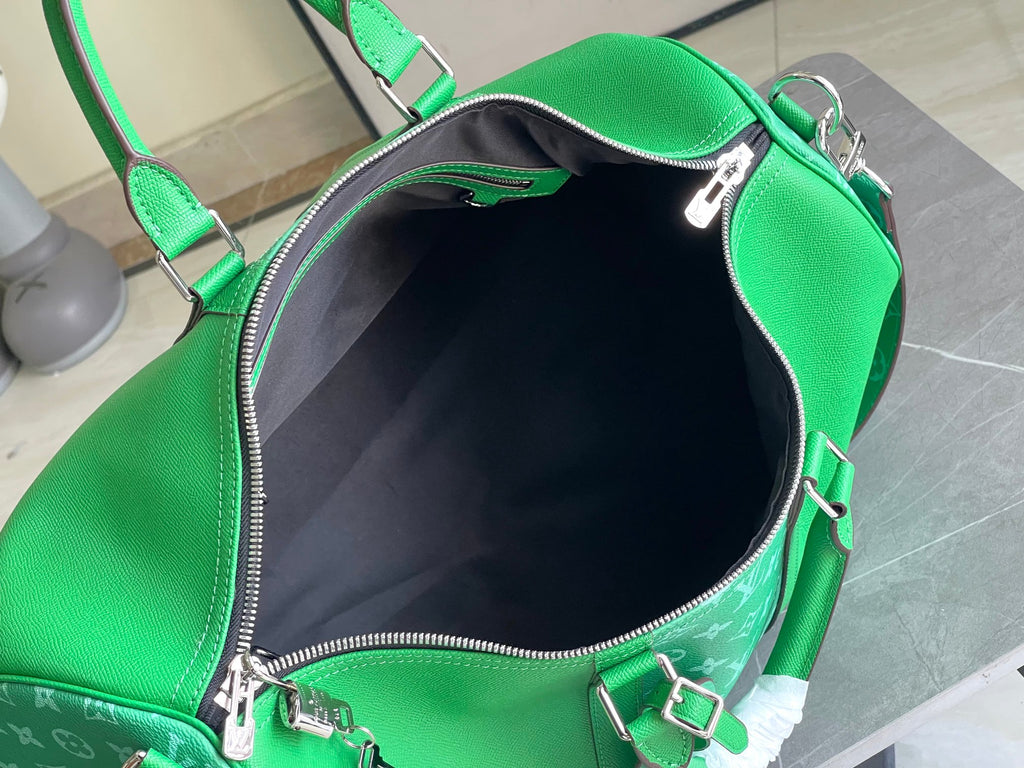 Green Louis Vuitton handbag interior view with zip opening and smooth lining.