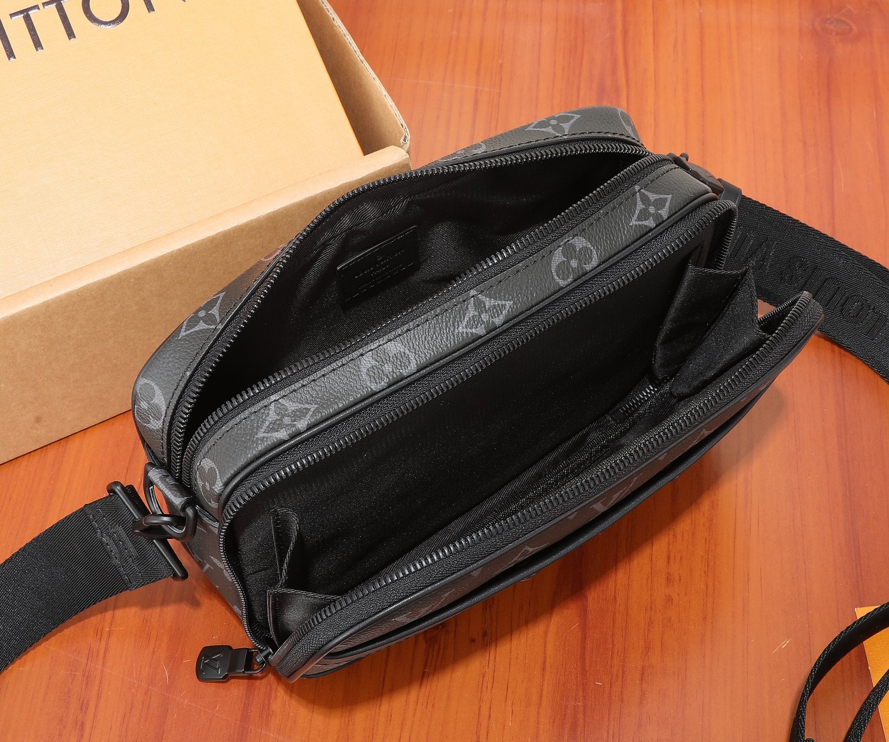 Louis Vuitton monogram crossbody bag with open top and dark interior compartments