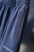 Balenciaga blue shorts with vertical seam details and logo near hem