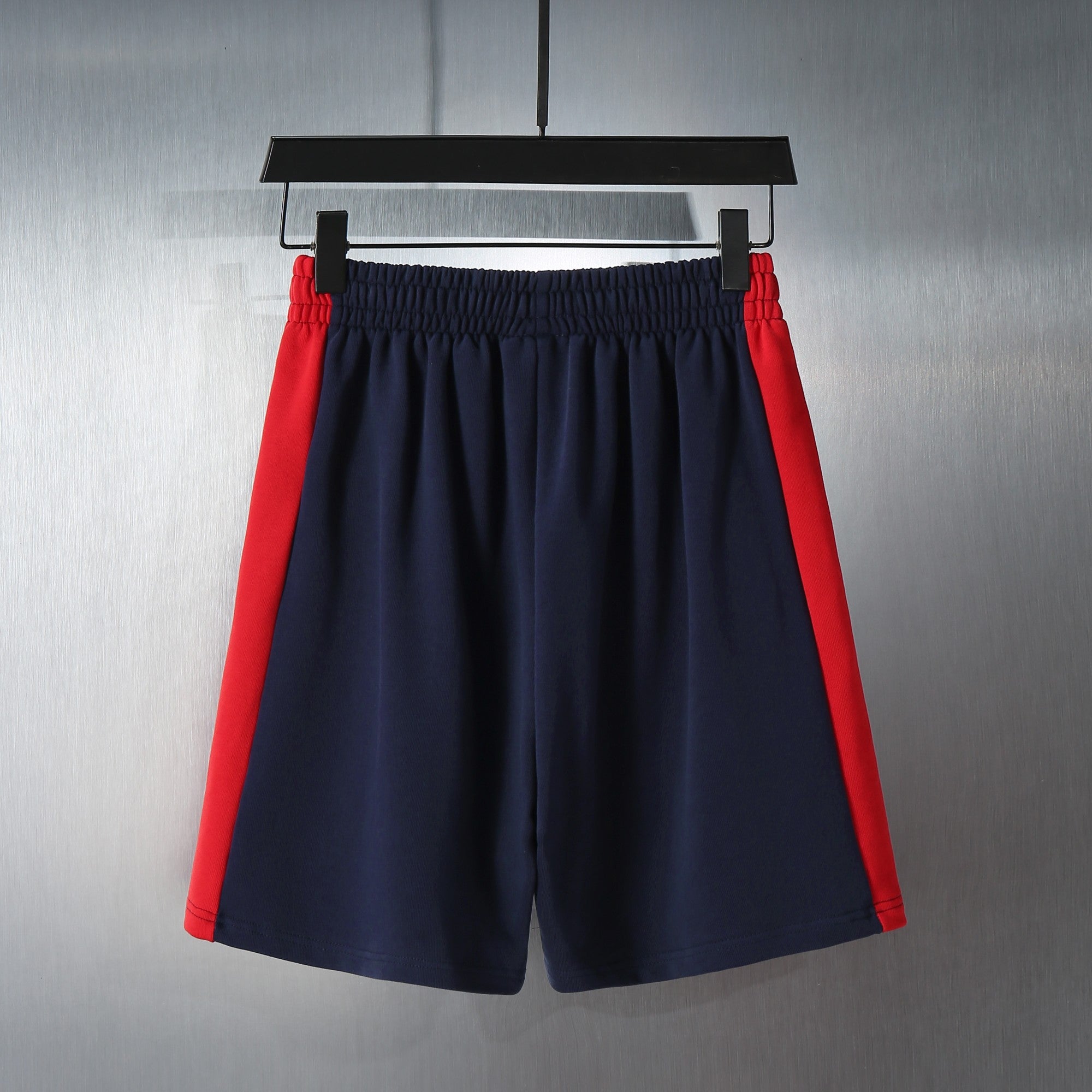 Navy shorts with red side panels and elastic waistband