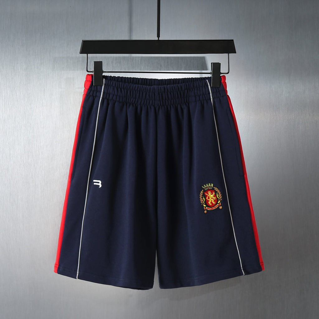 Navy shorts with elastic waistband and embroidered crest logo on the front leg