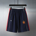 Navy shorts with elastic waistband and embroidered crest logo on the front leg