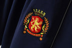 Embroidered crest patch with laurel details on navy shorts