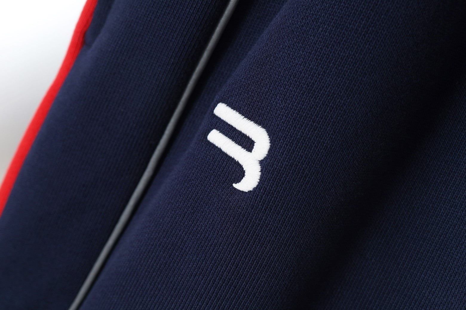 White logo mark on navy fabric shorts
