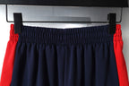 Navy shorts with red side stripes and elastic waistband