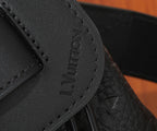Louis Vuitton leather bag close-up of embossed logo on side panel