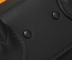 Black leather satchel front with snap buttons and textured panel