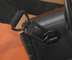 Louis Vuitton bag close-up of metal carabiner and leather strap loop