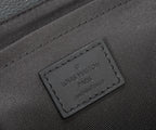 Louis Vuitton men's bag leather brand tag close-up on dark textured panel.