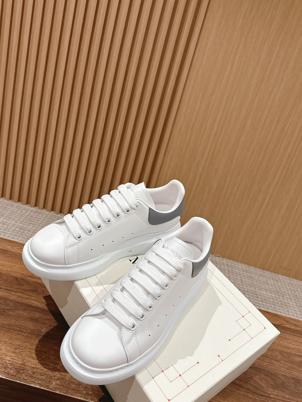 Alexander McQueen white leather sneakers with laces, two shoes and shoebox