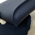 Hermes bag close-up of dark blue leather edge and pebbled texture.