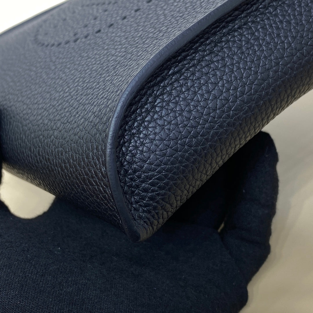 Hermes bag close-up of dark blue leather edge and pebbled texture.
