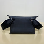 Hermes crossbody bag with dark blue leather body, top straps, and metal rings.
