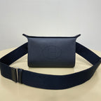 Hermes crossbody bag in dark blue leather with front logo and wide strap.