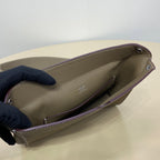 Hermes taupe crossbody bag side view with dark lining and silver zipper pull