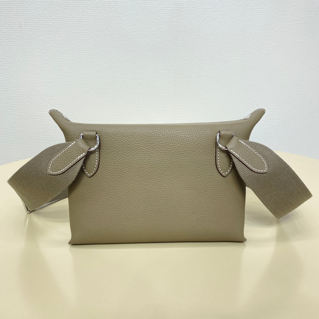 Hermes crossbody bag with taupe leather front and two side D-ring attachment points