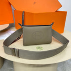 Hermes crossbody bag in taupe leather with front H-stamp and adjustable gray strap