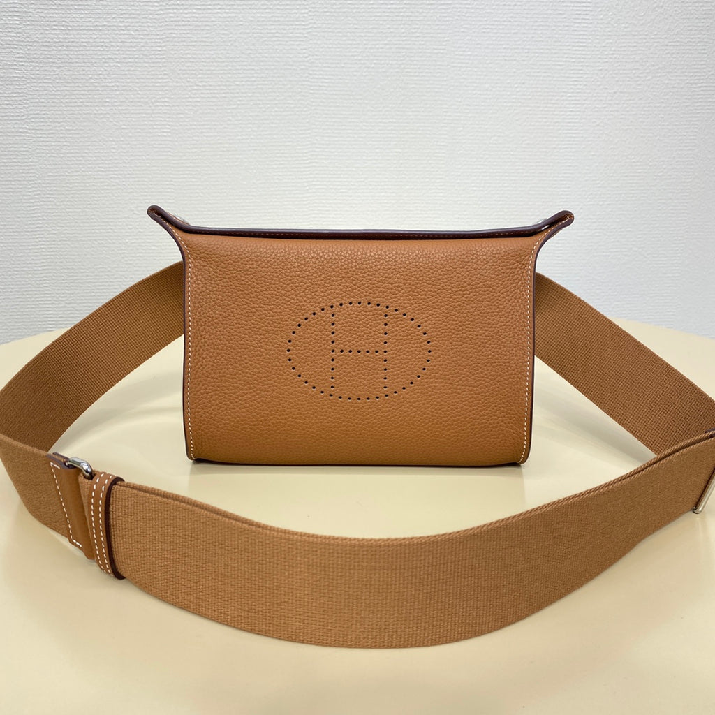 Hermes crossbody bag in tan leather with front logo stamp and canvas strap