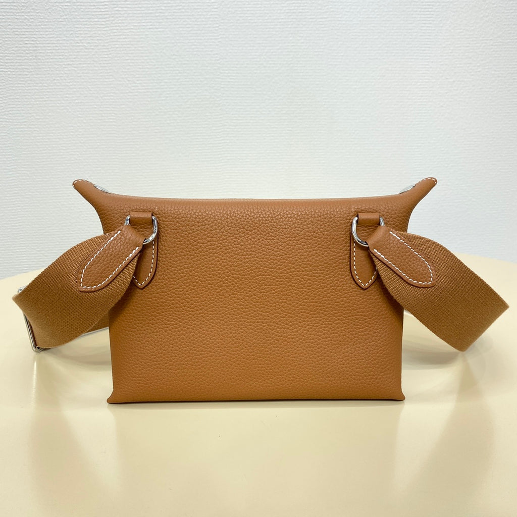 Hermes leather shoulder bag with top handles and logo front detail, tan