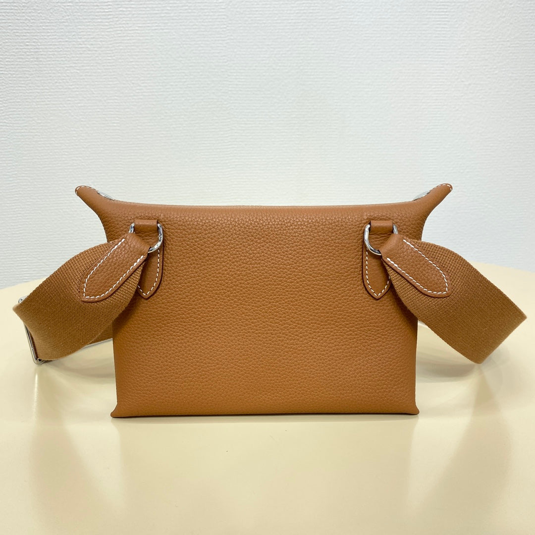 Hermes leather shoulder bag with top handles and logo front detail, tan