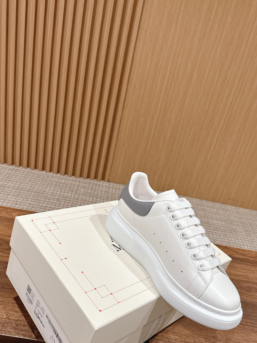 Alexander McQueen white leather low-top sneaker with lace-up and side strap detail