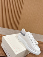 Alexander McQueen white leather low-top sneaker with lace-up and side strap detail