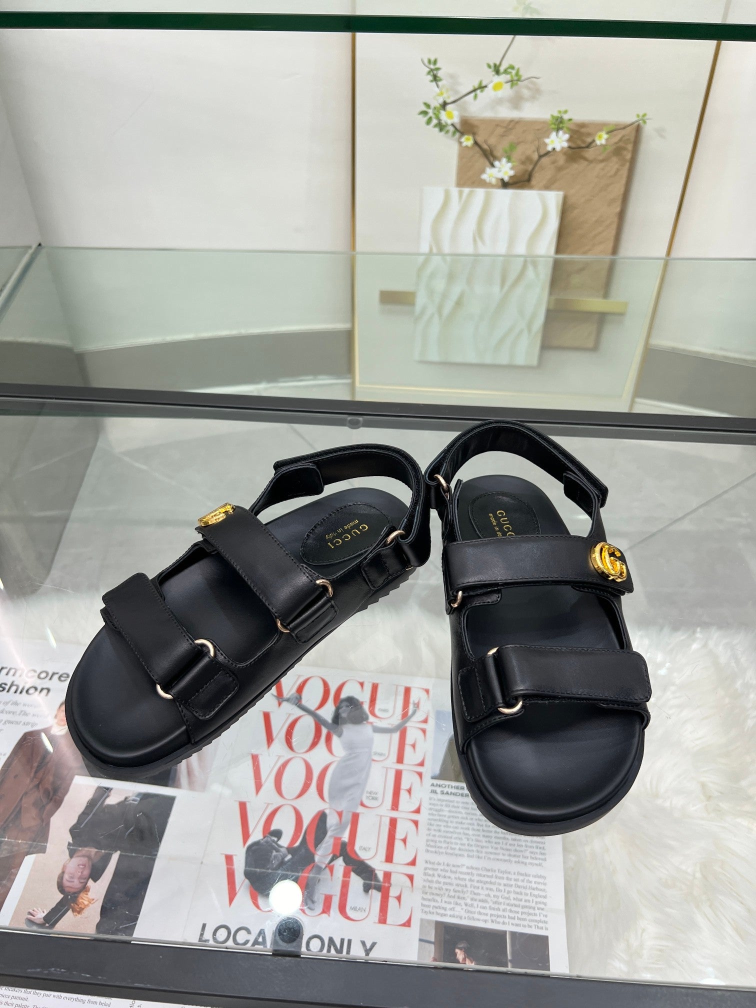 Gucci black platform sandals with two buckled straps and gold logo hardware