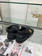 Gucci black sandals with cushioned footbed and gold-tone buckle hardware