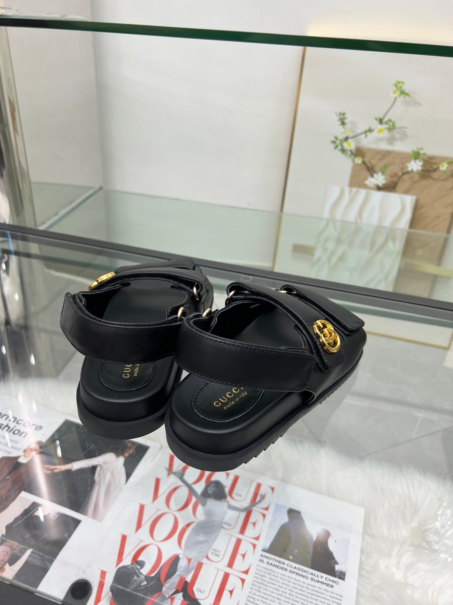 Gucci black sandals with cushioned footbed and gold-tone buckle hardware