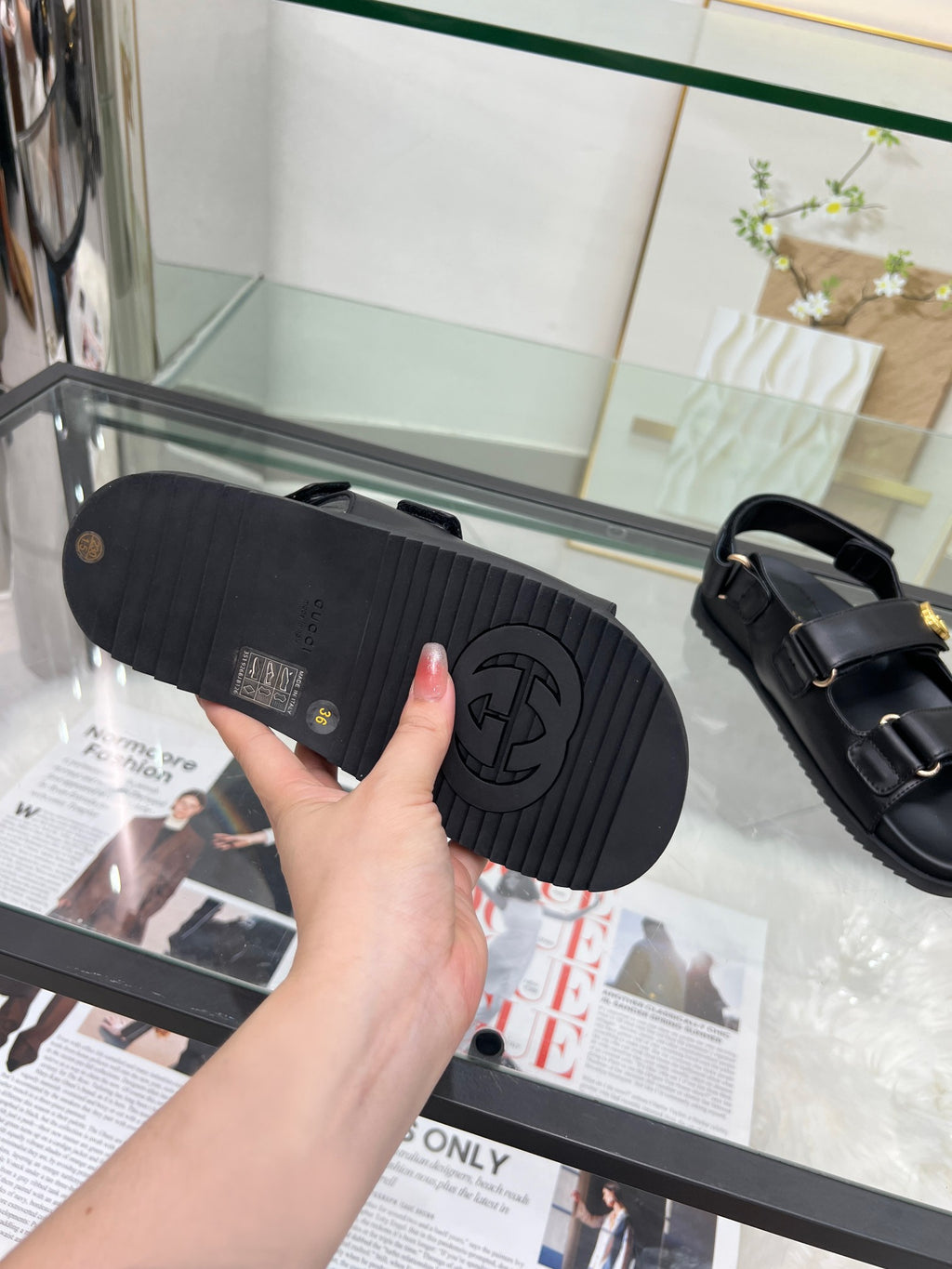 Gucci black sandal outsole with tread pattern and logo at heel